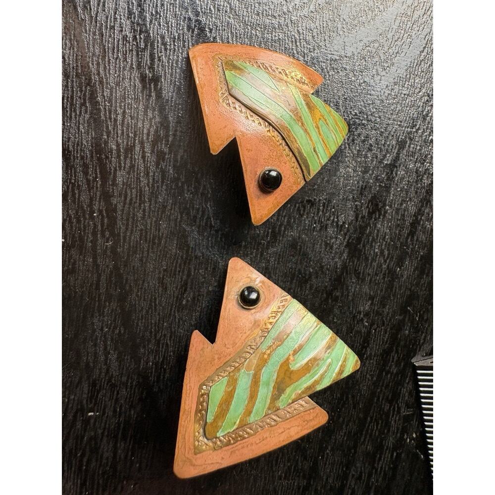 Artisan made copper earrings in the shape of fish with black stone eyes